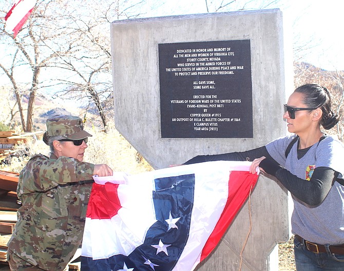 U.S. Air Force Maj. Lisa Maciel from Travis Air Force Base, left, and Jannal Milich unveil a new monument for VFW Post in Virginia City. (Steve Ranson/LVN)