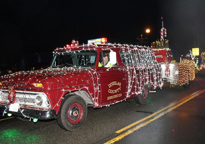 The old Douglas County Engine Co. ambulance decorated for the 2019 Parade of Lights and towing the Minden calliope. Kurt Hildebrand/R-C File Photo