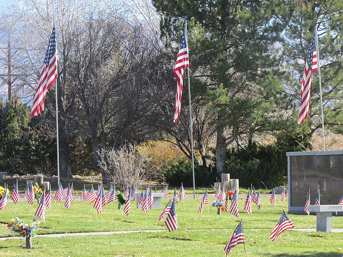 Flags decorate the graves of veterans at Eastside Memorial Park in Minden on Veterans Day.