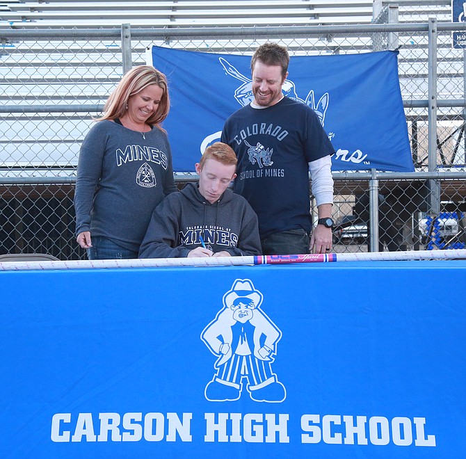 Carson High’s Kai Miller signs his Letter of Intent to continue his track and field career at the Colorado School of Mines Wednesday afternoon on the Carson High track.