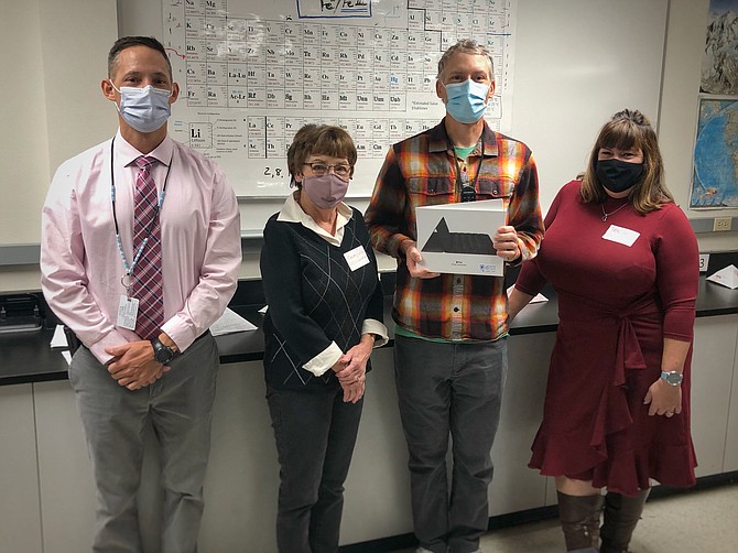 From left, Carson High School Principal Bob Chambers, Casey Gilles of the Carson City Schools Foundation, CHS Discovery Science teacher Gary Casselman and Patty Chang of Greater Nevada Credit Union pose for a photo as Casselman receives an iPad and keyboard.