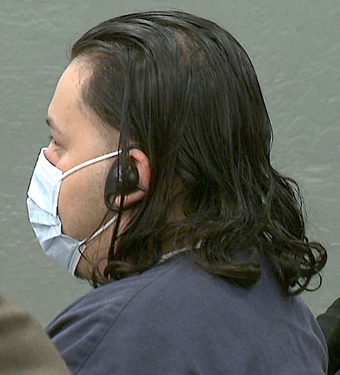 Wilber Martinez-Guzman wears headphones to hear his translator at his arraignment on murder charges in Douglas County District Court on Nov. 9. Photo by Wade Barnett/KOLO-TV