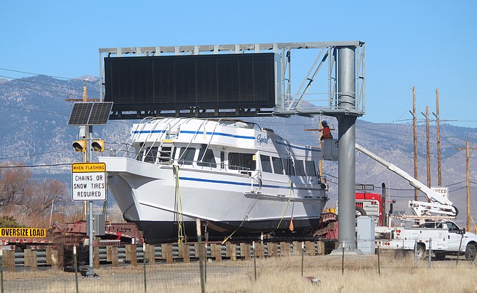 A crew eases the Spirit of Tahoe under the big reader board north of Minden on Wednesday morning.