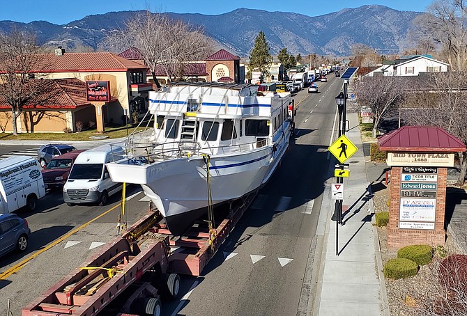 Eric Matus was in the bucket truck hanging decorations for Gardnerville when the Spirit of Tahoe chugged through town on Wednesday.