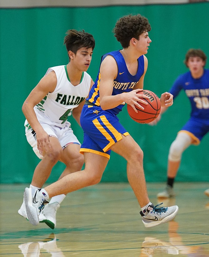 Trenton Schouten of South Tahoe dribbles past the Greenwave’s Francisco Tapia during a game Dec. 1, 2021 in Fallon. (Photo: Thomas Ranson/LVN)