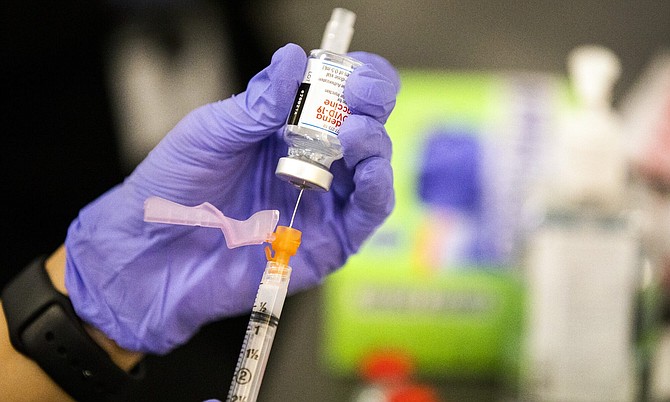 A medical staff member prepares a COVID -19 vaccine during the Amazon employees Covid-19 vaccination event at the Amazon Fulfillment Center in North Las Vegas on Wednesday, March 31, 2021.