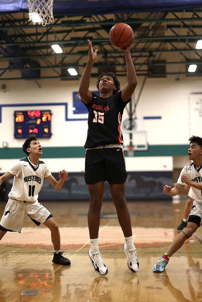 Theo Reid (35) goes up for a shot attempt in the paint Tuesday night against Damonte Ranch. Reid had four points in the Tigers' loss.