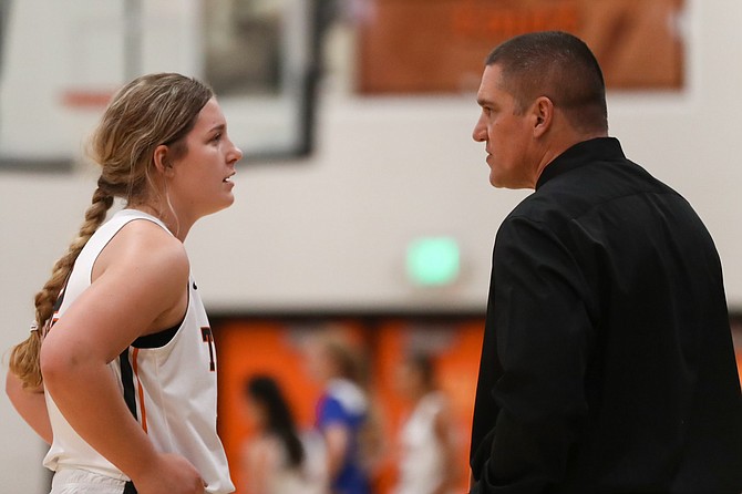 Riley Mello talks with her father and Douglas High girls’ head coach Brian Mello during a contest two seasons ago. Both are anxious to see what the Tigers can do on the floor this winter after nearly a two-year layoff.