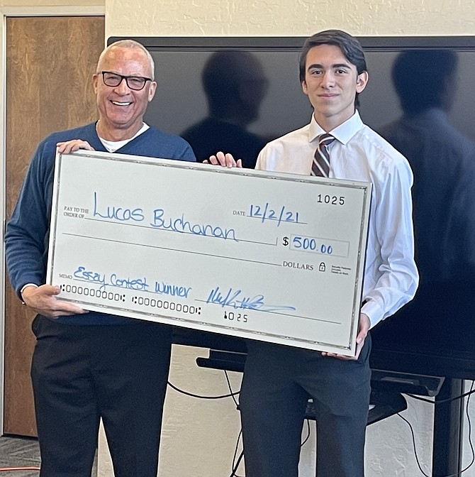 Lucas Buchanan, a senior at Dayton High, accepts $500 for winning the Adams Hub for Innovation in partnership with NV Production House, ‘Entrepreneurial Spirit Essay’ contest.