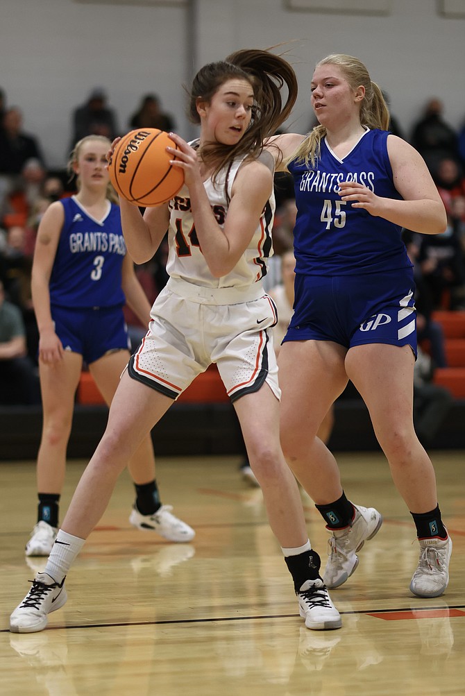 Douglas High's Addy Doerr (14) works with her back to a defender Firday night in the Tigers' home opener. Doerr had a team-high 14 points, 12 of which came in the second half in the Tigers' win.