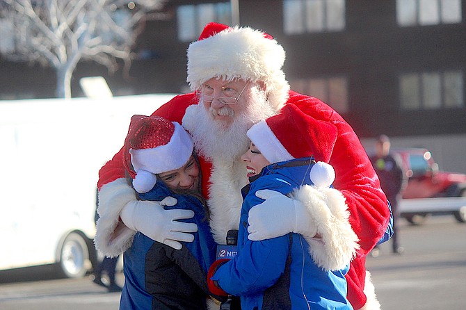 Santa greets two Channel 2 newspeople in Minden on Friday morning.