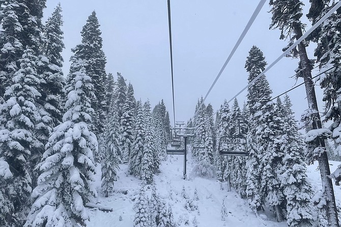 In this photo provided by the Northstar Ski Resort, fresh snow surrounds a ski lift in Truckee, Calif., on Dec. 13, 2021. (Shannon Buhler/Northstar Ski Resort via AP)