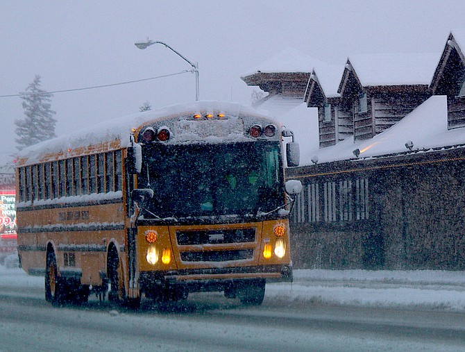 A bus travels on Highway 395 through Minden.