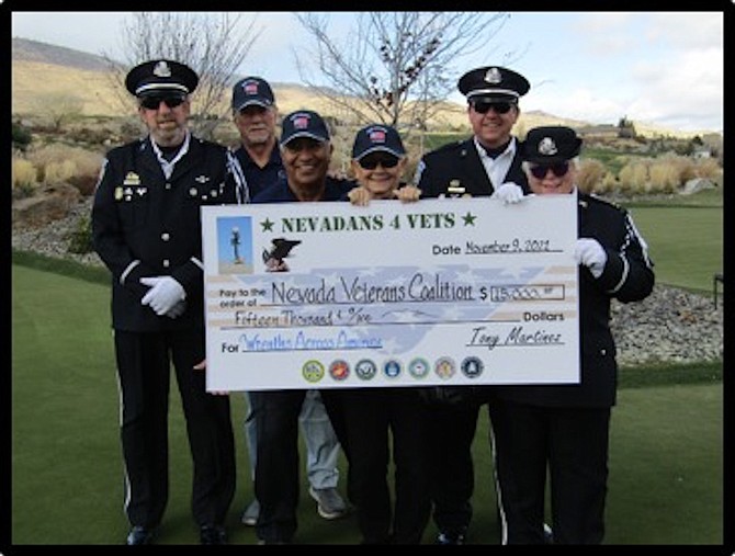 Nevadans 4 Vets presented the Northern Nevada Coalition with a check for $15,000 to benefit Wreaths Across America. Wreaths Across America honors our fallen heroes with wreath- laying ceremonies the third December each year. The donation to the Northern Nevada Coalition was presented at ArrowCreek Country Club, the location of the golf tournament fundraising event. Tony Martinez, the Founder of Nevadans 4 Vets, expressed his appreciation to ArrowCreek Management and Staff for a successful event and special thanks to all members, guests and volunteers who contributed to this worthy cause.
Front row, from left are David Ritfin, vice president of the Northern Nevada Coalition, Tony Martinez, Founder Nevadans 4 Vets; Diane Martinez, volunteer coordinator, Nevadans 4 Vets; and Sharon Serenko, treasurer, Northern Nevada Coalition. Back row, from left are  Larry Roffelsen, president,  Nevadans 4 Vets, and Rick Rose, president, Northern Nevada Coalition.