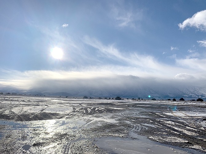 Clouds begin to crest the Carson Range above Carson Valley on Wednesday afternoon in this photo by Comstock Seed owner Ed Kleiner.