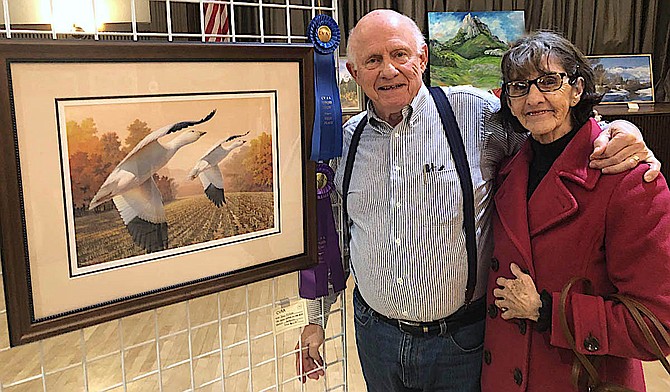 Don Fotine and wife Connie with his winning painting 'Snow Geese' at the Carson Valley Art 
Assocation Scholarship show.