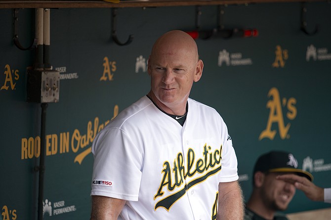 Then-Oakland Athletics third base coach Matt Williams in the dugout before a game against the Texas Rangers on Sept. 22, 2019, in Oakland, Calif. (AP Photo/D. Ross Cameron)