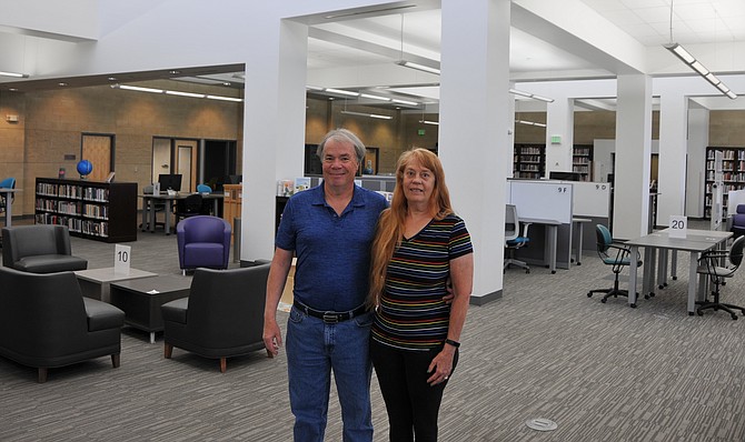 John McDougall and life partner Debbie Dubuc have their photo taken in Western Nevada College’s reimagined Joe Dini Library.