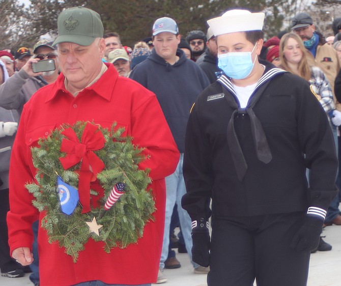 U.S. Marine veteran Robert Harris and Sea Cadet Lucia Perez prepare to place a wreath at the Northern Nevada Veterans Memorial Cemetery’s U.S. Marine memorial.