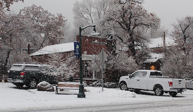 Snow falls in downtown Genoa on Thursday afternoon.