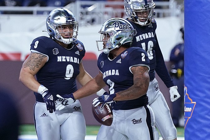 Nevada running back Devonte Lee (2) celebrates after scoring in the Quick Lane against Western Michigan on Dec. 27, 2021, in Detroit. (AP Photo/Carlos Osorio)