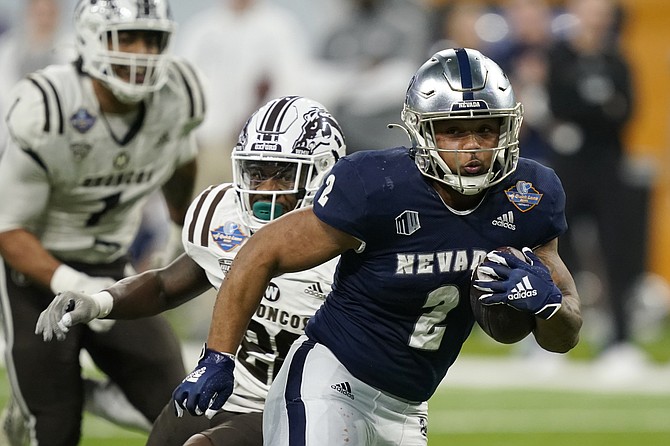 Nevada running back Devonte Lee (2) rushes during the second half of the Quick Lane Bowl against Western Michigan on Dec. 27, 2021, in Detroit. (AP Photo/Carlos Osorio)
