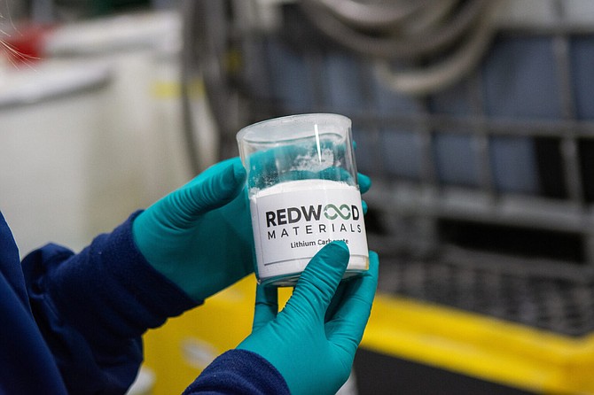 An employee holds lithium carbonate inside Redwood Materials' facility in in Carson City on Oct. 20, 2021.