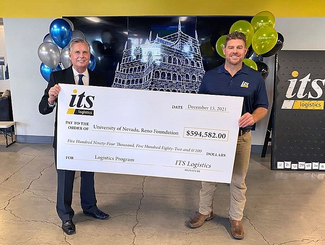 Greg Mosier, dean of the College of Business at UNR, left, and Mike Crawford, president of Integrated National Capacity at ITS Logistics, hold the $594,582 check.