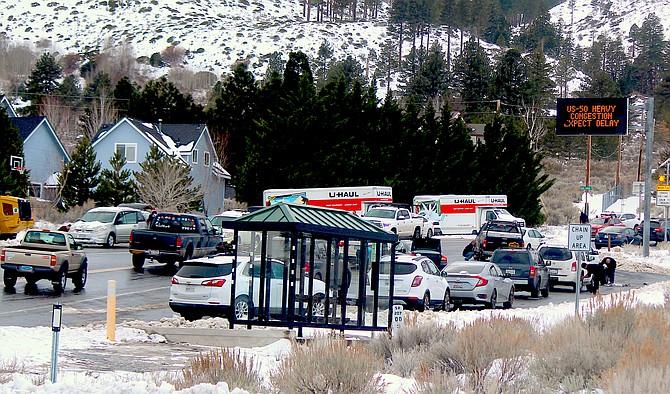 Travelers stop at the base of Kingsbury Grade to chain up on Tuesday afternoon.