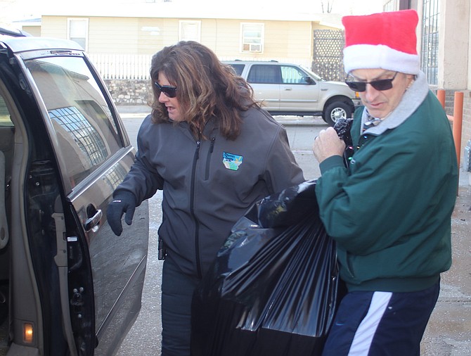 Dave Tilley, right, of CC Communications takes a bag of toys and clothes to a vehicle with the help of LaKrisha Ernst, Churchill County Facilities/Parks & Recreation.