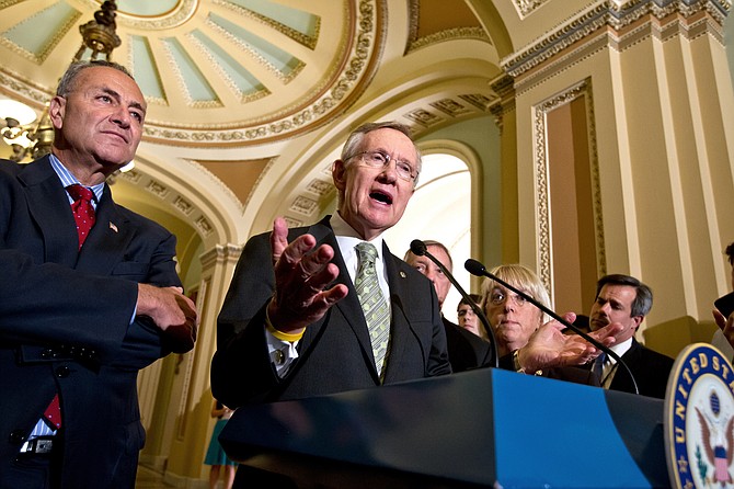 Then- Senate Majority Leader Harry Reid at the Capitol in Washington on July 25, 2012. From back left are Sen. Charles Schumer, D-N.Y., Sen. Richard Durbin, D-Ill., and Sen. Patty Murray, D-Wash. (AP Photo/J. Scott Applewhite, file)