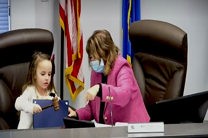 Abby Bindley, age 5, bangs the gavel to adjourn the Board of Supervisors meeting Thursday morning.