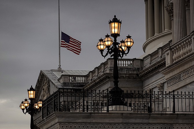 The flag flies at half-staff at the U.S. Capitol in Washington on Dec. 29, 2021, to honor longtime Senate Majority Leader Harry Reid of Nevada. (AP Photo/J. Scott Applewhite)