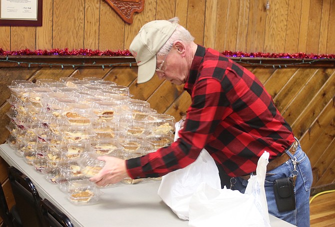 Lance McNeil lines up the desserts for the containers.