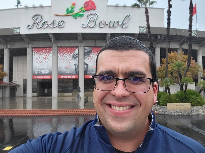 Carson High band director Nicolas Jacques in front of the Rose Bowl for the 2022 Rose Parade.