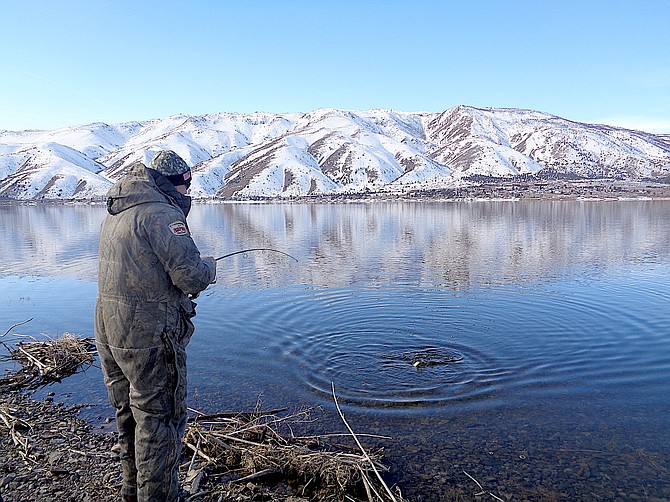 Tom Blotter reeling in a fish at Topaz Lake.