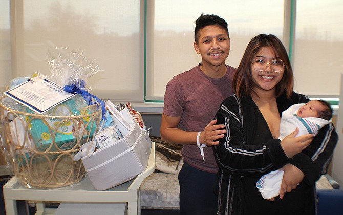 Roberto James and Brittney Amorsolo pose for a photo with their newborn son, Theodore, at Banner Health in Fallon.
