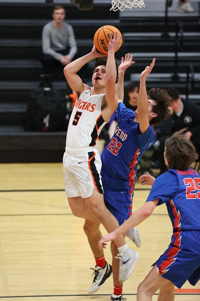 Dakota Jones (5) raises up for a bucket Tuesday night in the Tigers' second win over Reno High this season.