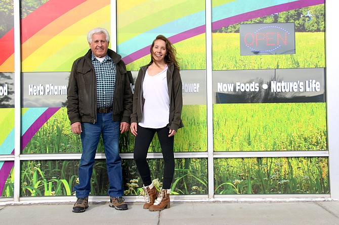 Rich and Richone Cancimilla, father and daughter duo at Lifestream Health Foods, stand under their new window art. Rich said that he hopes the rainbow becomes part of their store identity.