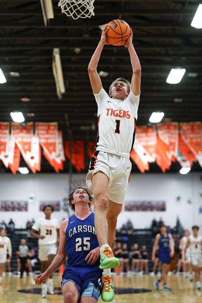 Douglas High senior Kasen Boggs (1) rises up for a first half dunk in transition against Carson Thursday night. Boggs finished with a game-high 16 points for the Tigers.