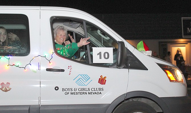 Brenda Robertson waves from the Boys & Girls Club entry in the Parade of Lights in December.