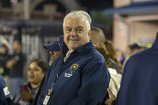 Nevada Gov. Steve Sisolak stands on the sidelines at Mackay Stadium during the UNLV-Nevada football game in Reno on Oct. 29, 2021. (AP Photo/Tom R. Smedes, file)