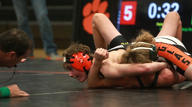 Hunter Morris looks for a pin at 120 pounds against Bishop Manogue on Wednesday.