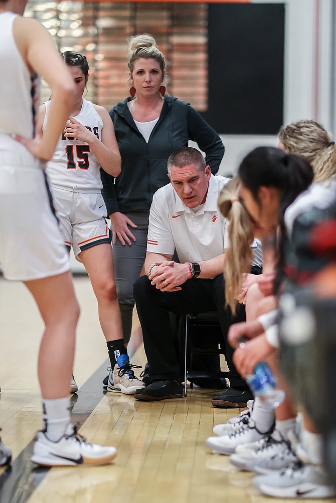 Brian Mello, seated, is no longer the head coach of the Douglas High girls basketball team as confirmed Friday morning by Douglas High athletic director, John Glover.