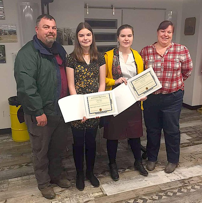 Addy LaCost, left, and Haylee LaCost, right, along with their parents.  Addy won the contest and will compete on Feb. 8. Photo by Dave Stewart