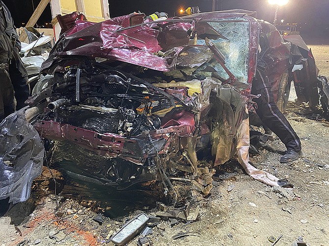 This photo released by the North Las Vegas Police Department shows a Dodge Challenger in North Las Vegas on Jan. 29, 2022. Las Vegas police said the driver and his passenger were among the dead after Saturday's crash and the ages of the other victims ranged from juveniles to middle-aged adults. (North Las Vegas Police Department via AP)