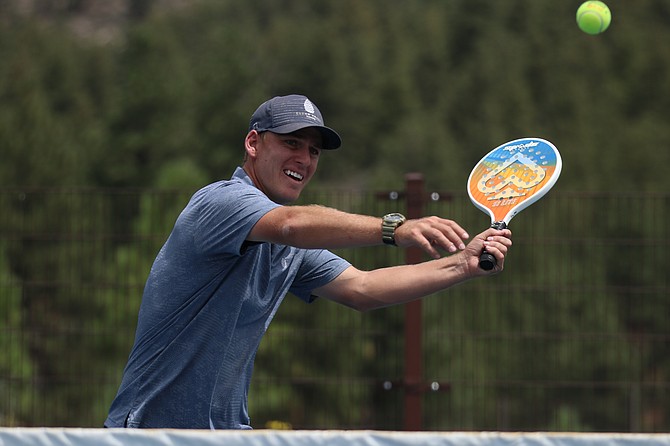SpecTennis founder and creator, Nate Gross, leans into a forehand volley while playing SpecTennis. Gross hopes his creation can help segue more players into tennis as well as find a niche for those looking to pick up a new racket sport.