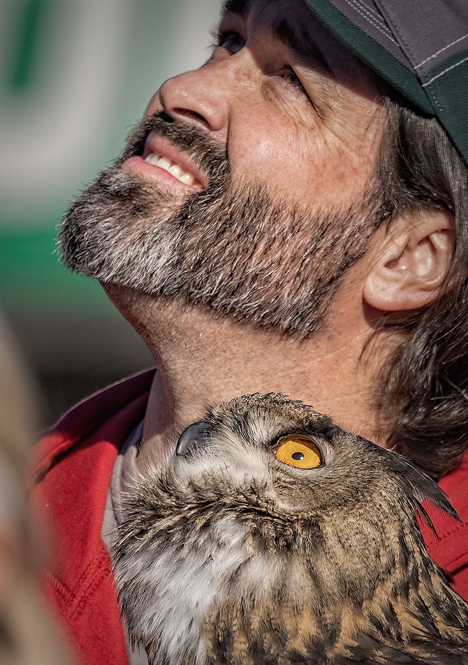 A man and his owl look up during Eagles and Ag over the weekend.