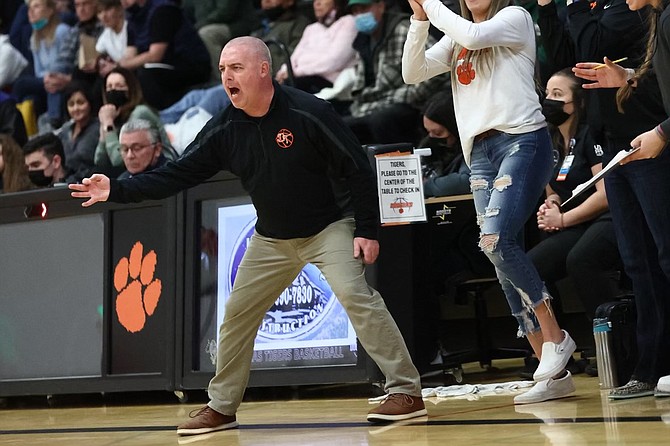 Douglas High interim coach Jason Carter gets into the action Tuesday night in the Tigers' home game against Bishop Manogue