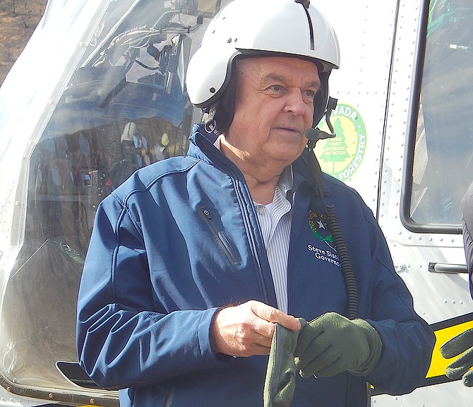 Gov. Steve Sisolak prepares to board a Nevada Division of Forestry helicopter being used for reseeding the region burned in the Tamarack Fire in southern Douglas County on Wednesday.